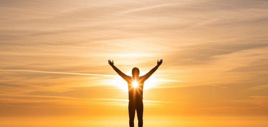 Christian standing in prayer at sunrise — overcoming fear with faith.