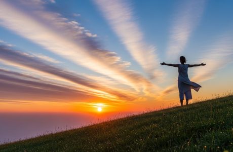 A person standing at sunrise representing letting go and trusting God for new beginnings.